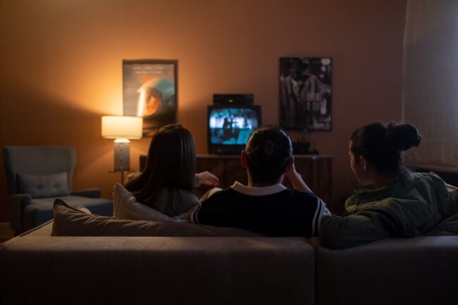 Family sitting and watching TV