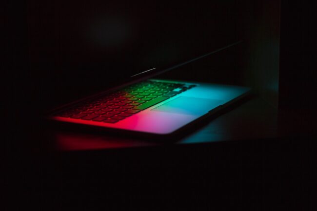 Open laptop with red, green, and blue light